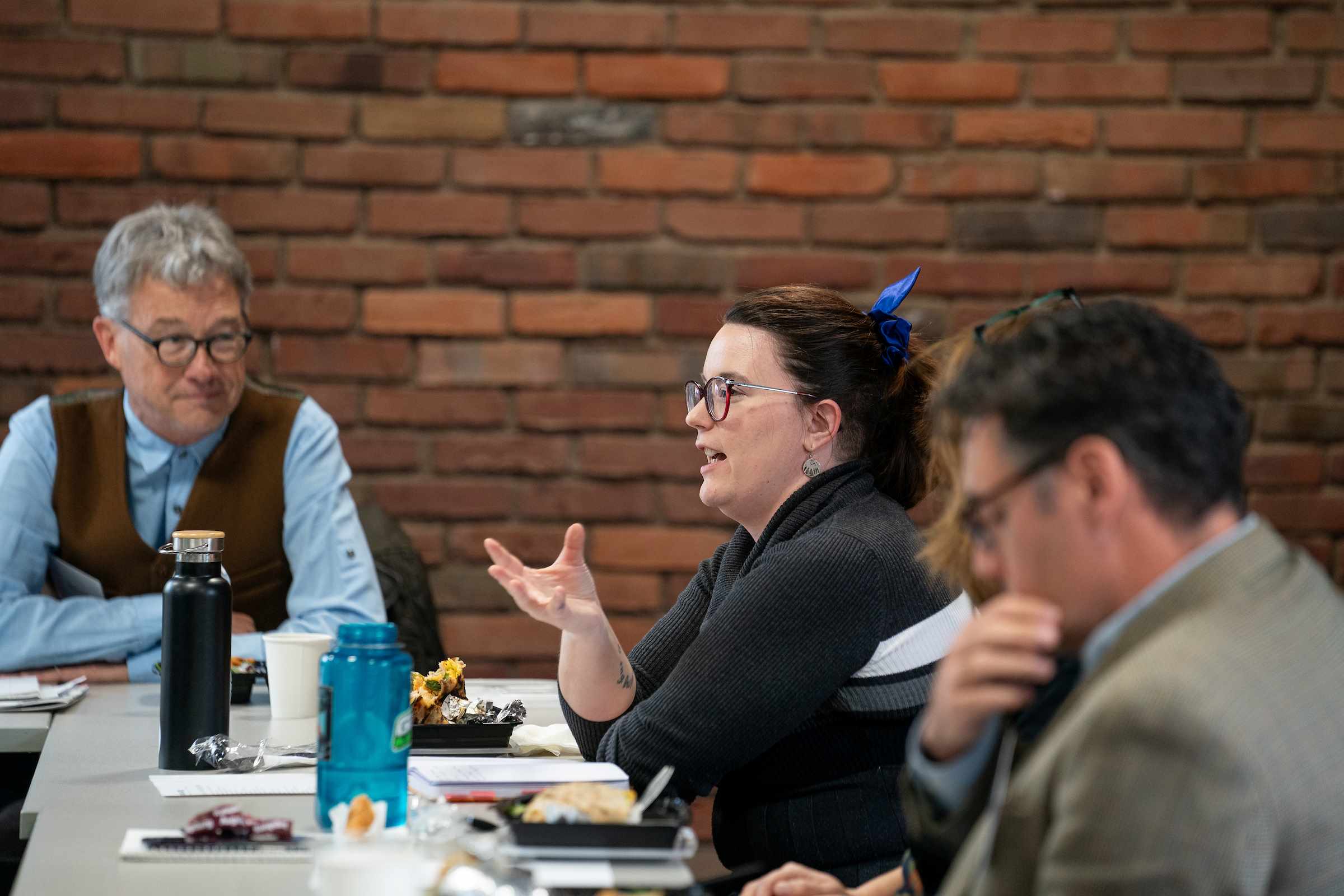 Three people having a coversation over lunch